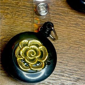 Self retracting ID badge with flower detail